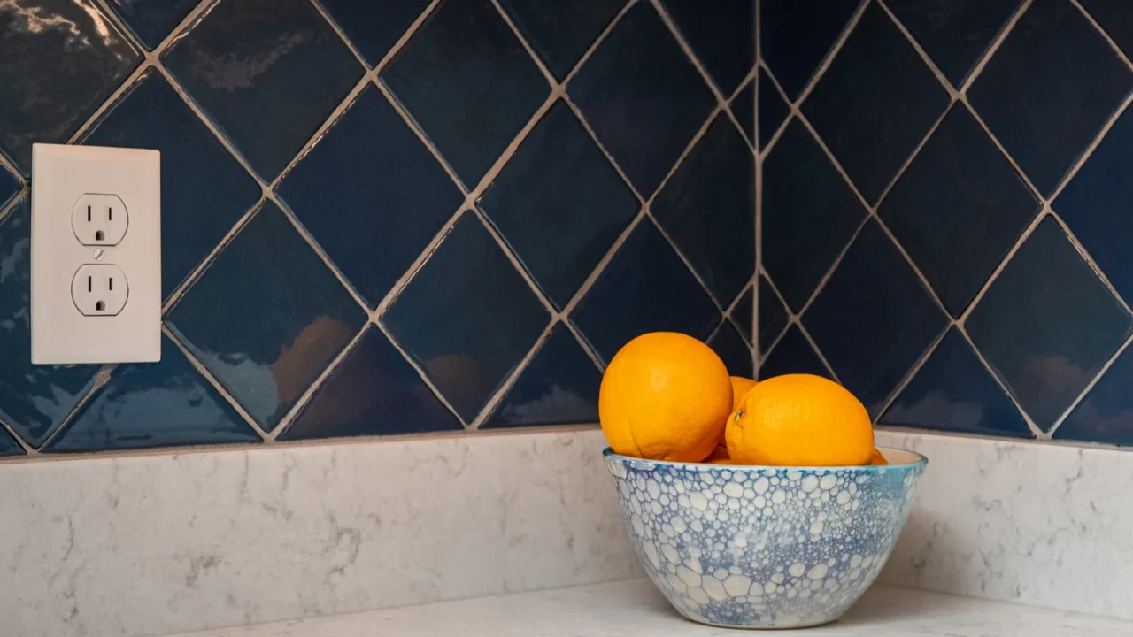 oranges in a blue and white bowl on a granite