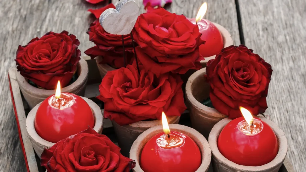 romantic decoration with roses and scented candles in wooden box