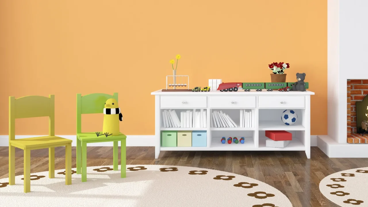 A stylish playroom interior with yellow and green chairs, a rug, and a white shelf with books and toys.