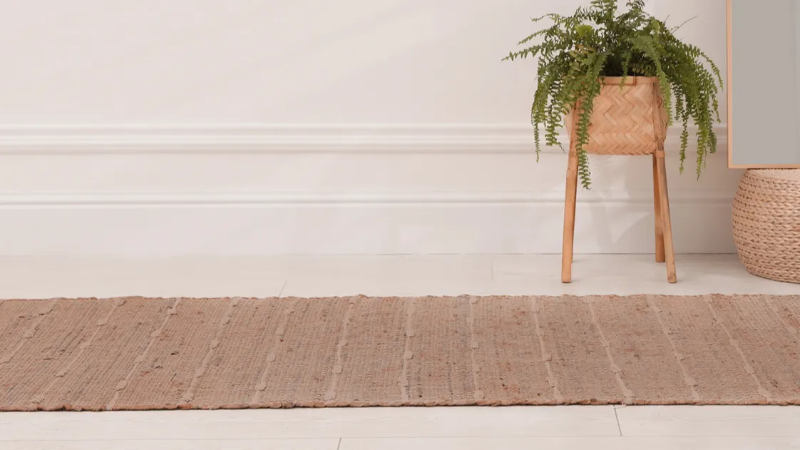 rug in shade of mocha mousse mirror and plant indoors