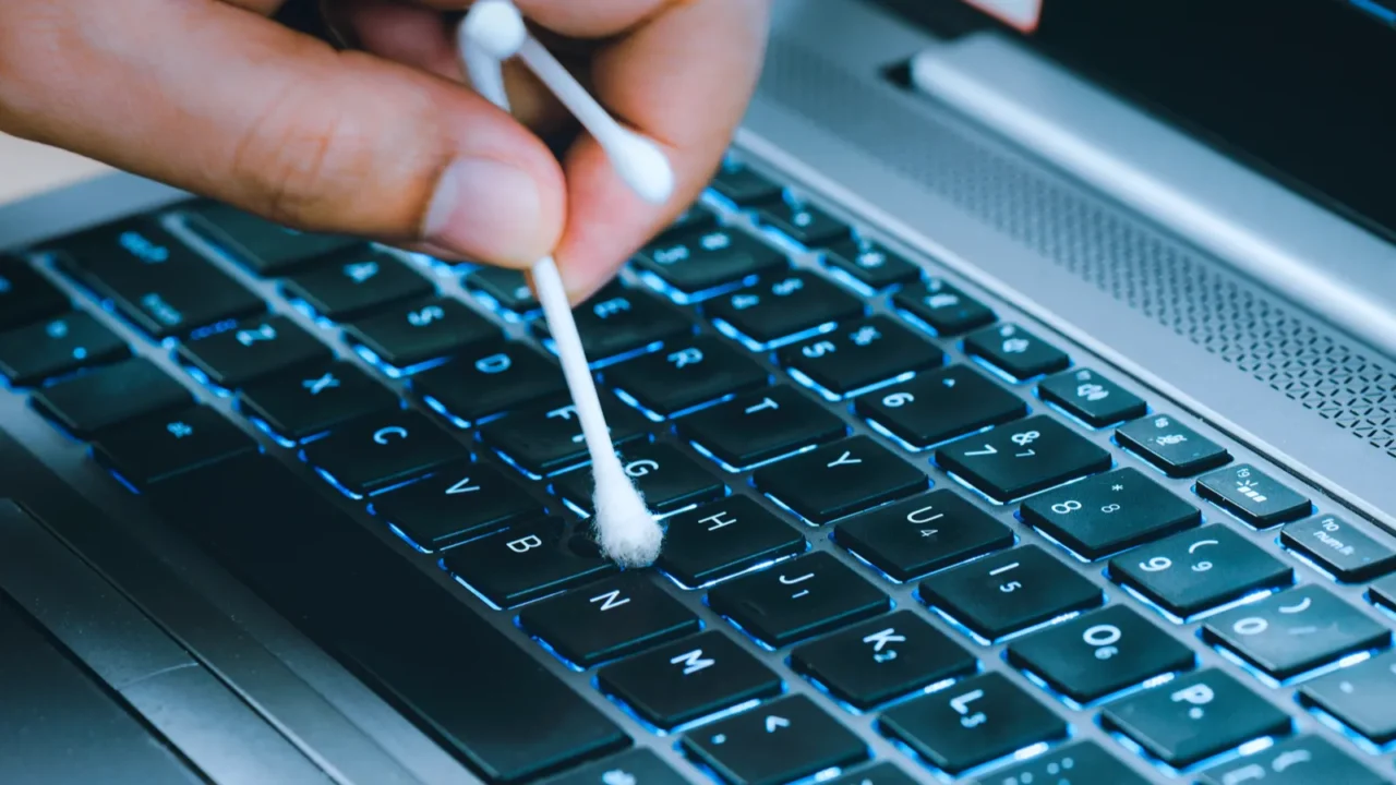 the left hand holds a cotton swab bud to clean