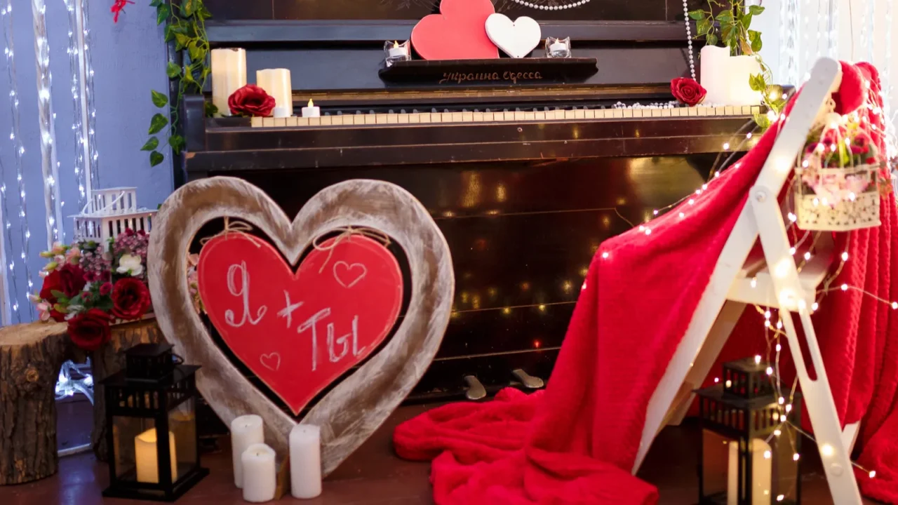 valentines day concept piano decorated with candles red wooden hearts