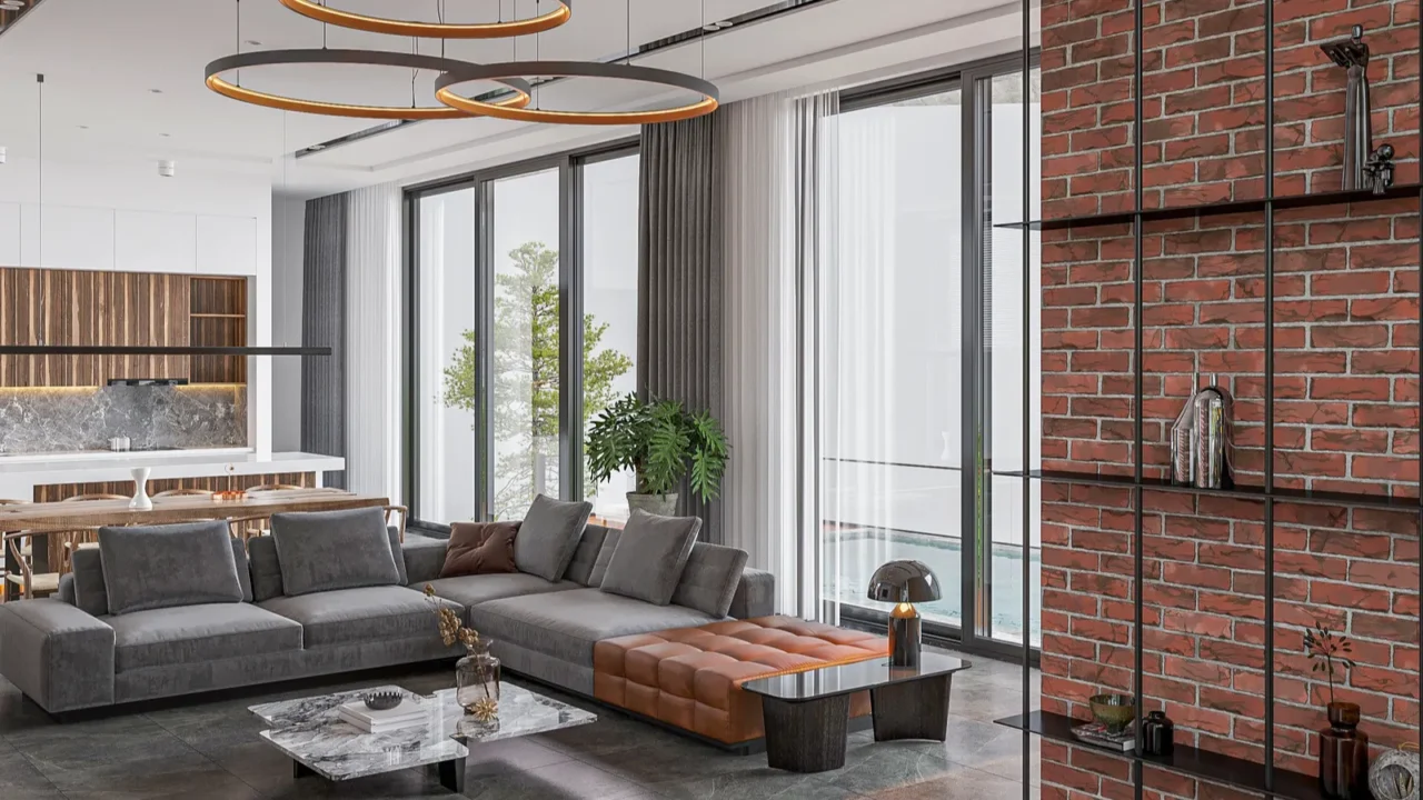 A contemporary living room with large windows, a sectional sofa, and a brick accent wall.