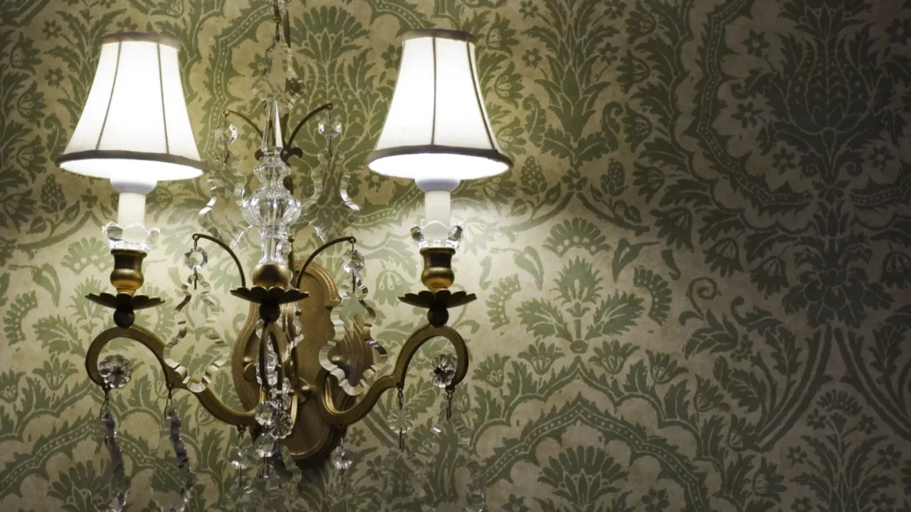 vintage lamp against a green patterned wallpaper