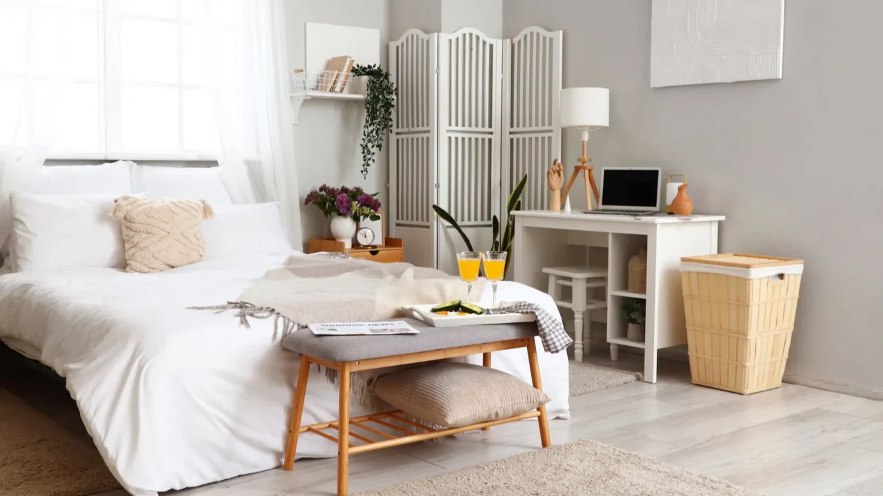 interior of light bedroom with breakfast and workplace