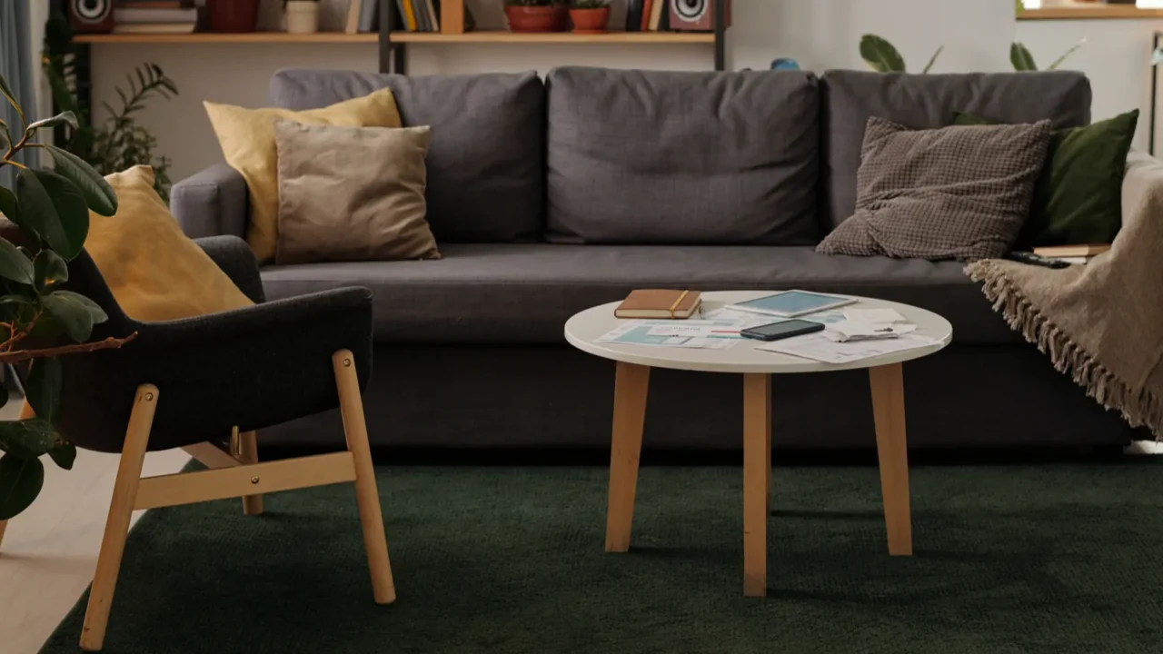 low round table with mobile gadgets financial bills and notepad