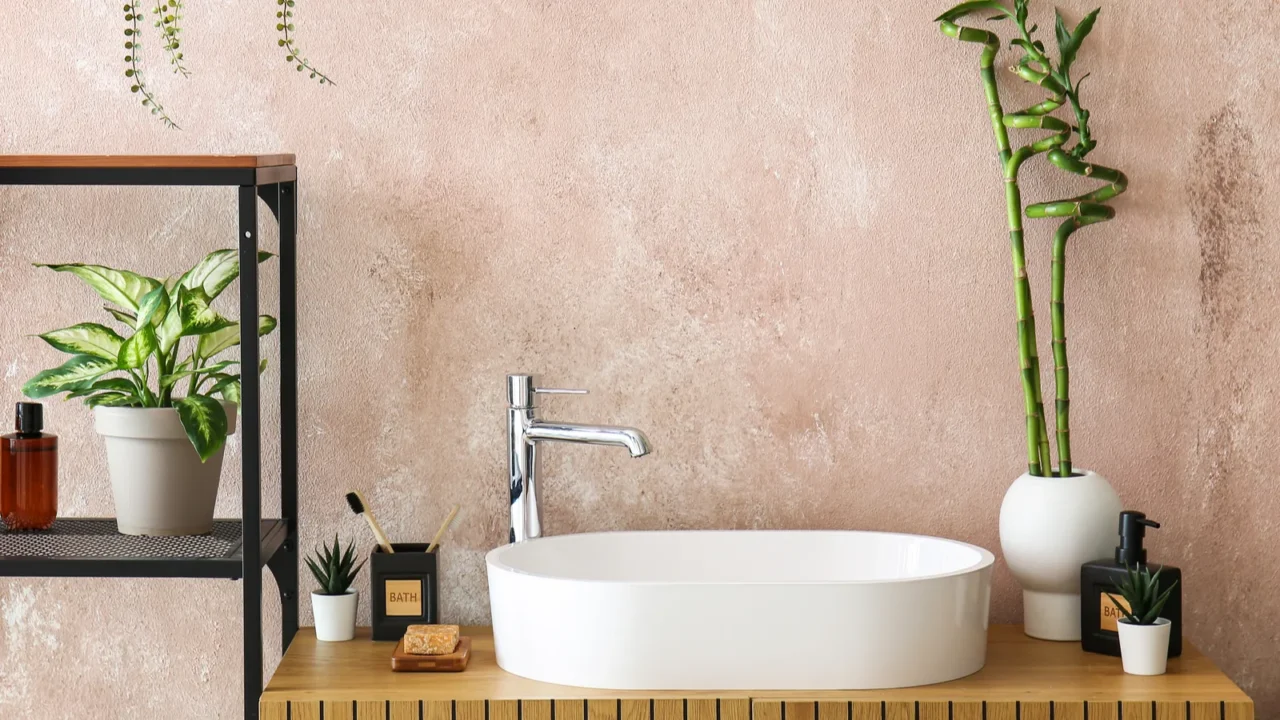 sink bath accessories and vase with bamboo stems on table