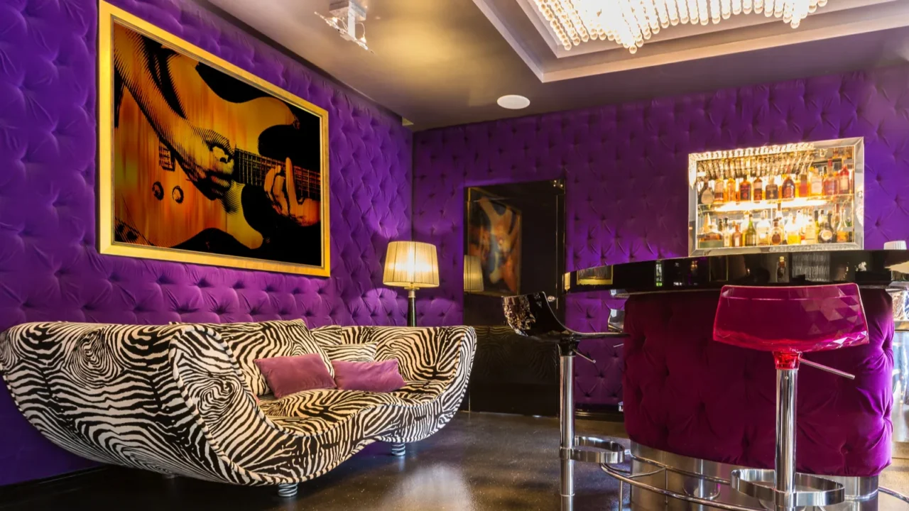 A luxurious purple lounge with a zebra-striped sofa and stylish decor.