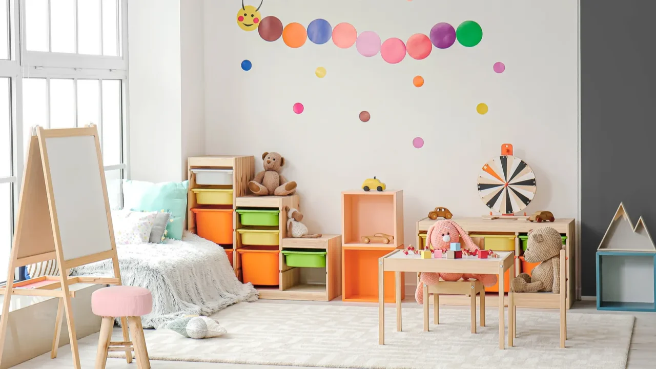 A playful kids room with a wooden table and chairs, art corner, colorful storage bins, toys, and a playful wall art.