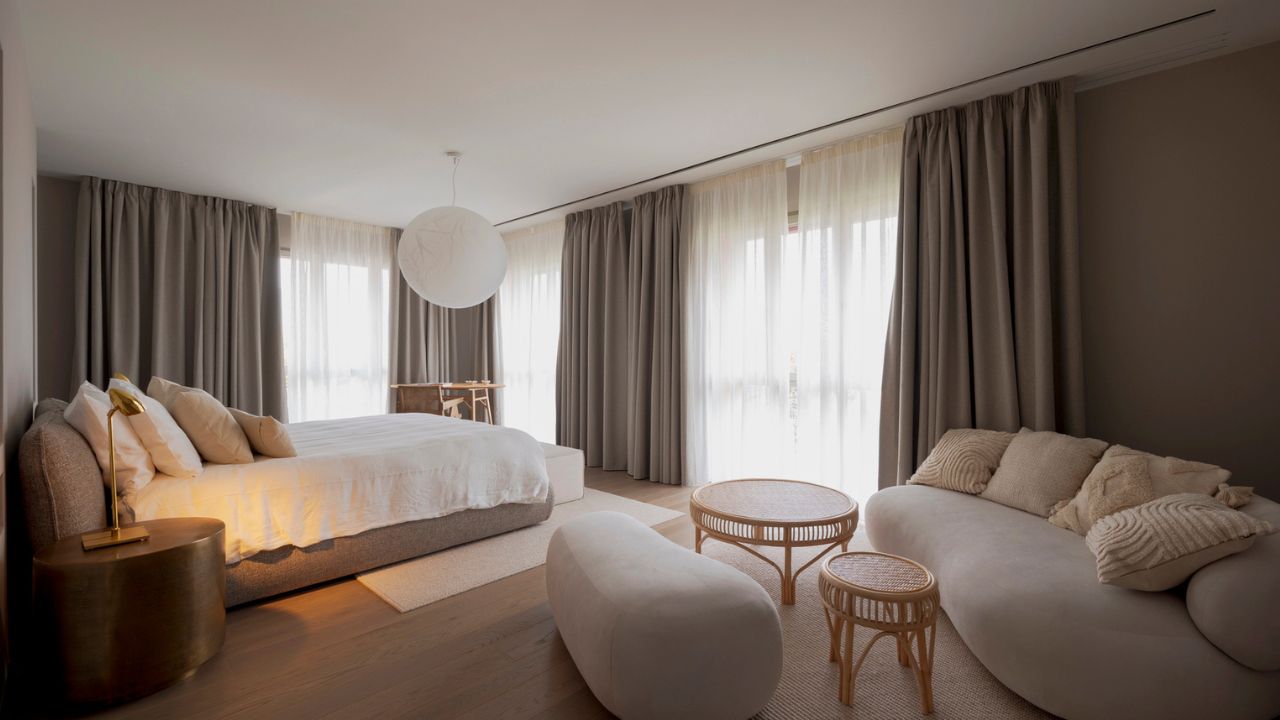 A modern bedroom with soft colors and stylish furniture.