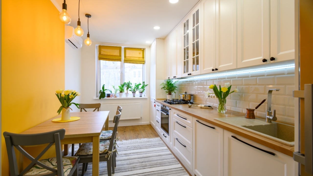 Cozy yellow-themed kitchen with flowers.