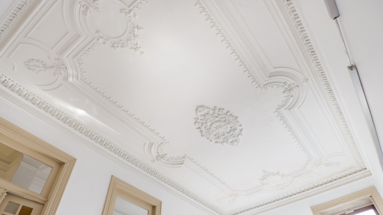 A beautifully detailed plaster ceiling with intricate designs.