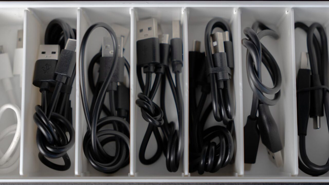 Neatly organized cables of different types in an organizer.