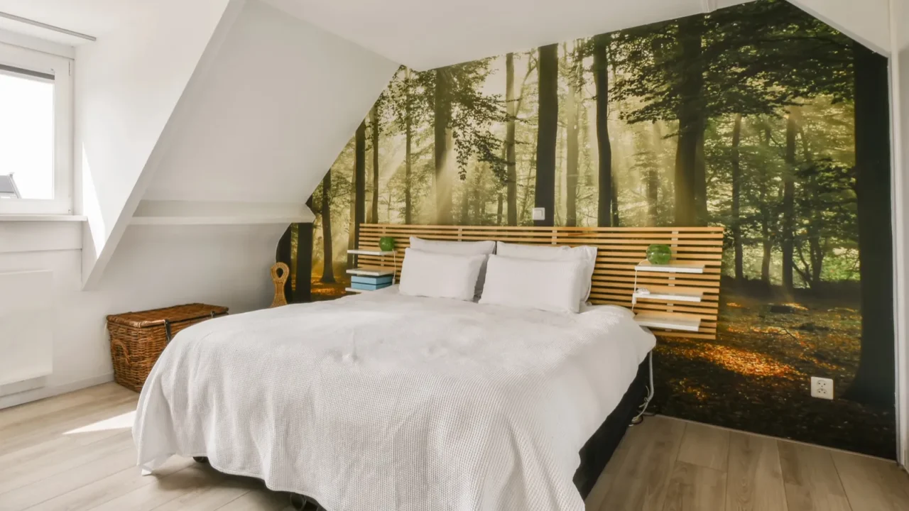a forest is on the wall next to the bed