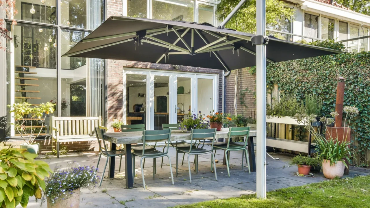 a spacious outdoor patio surrounded by lush greenery featuring a