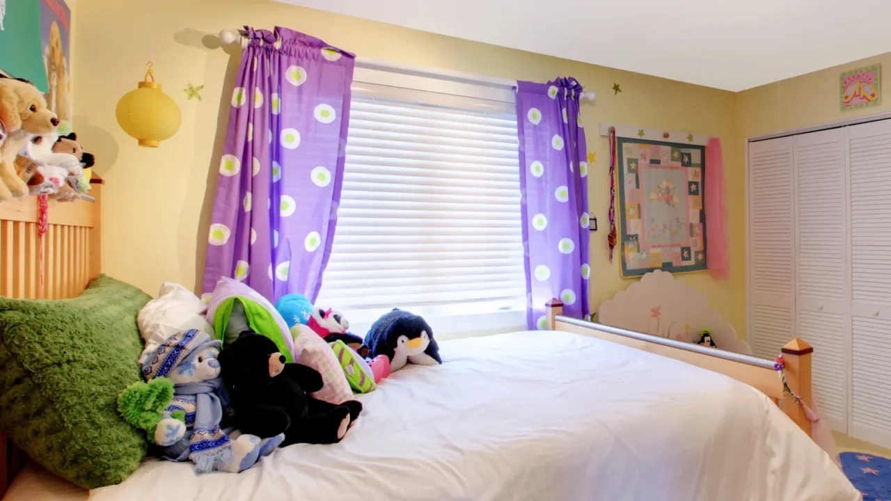 baby girl room with toys and purple curtains