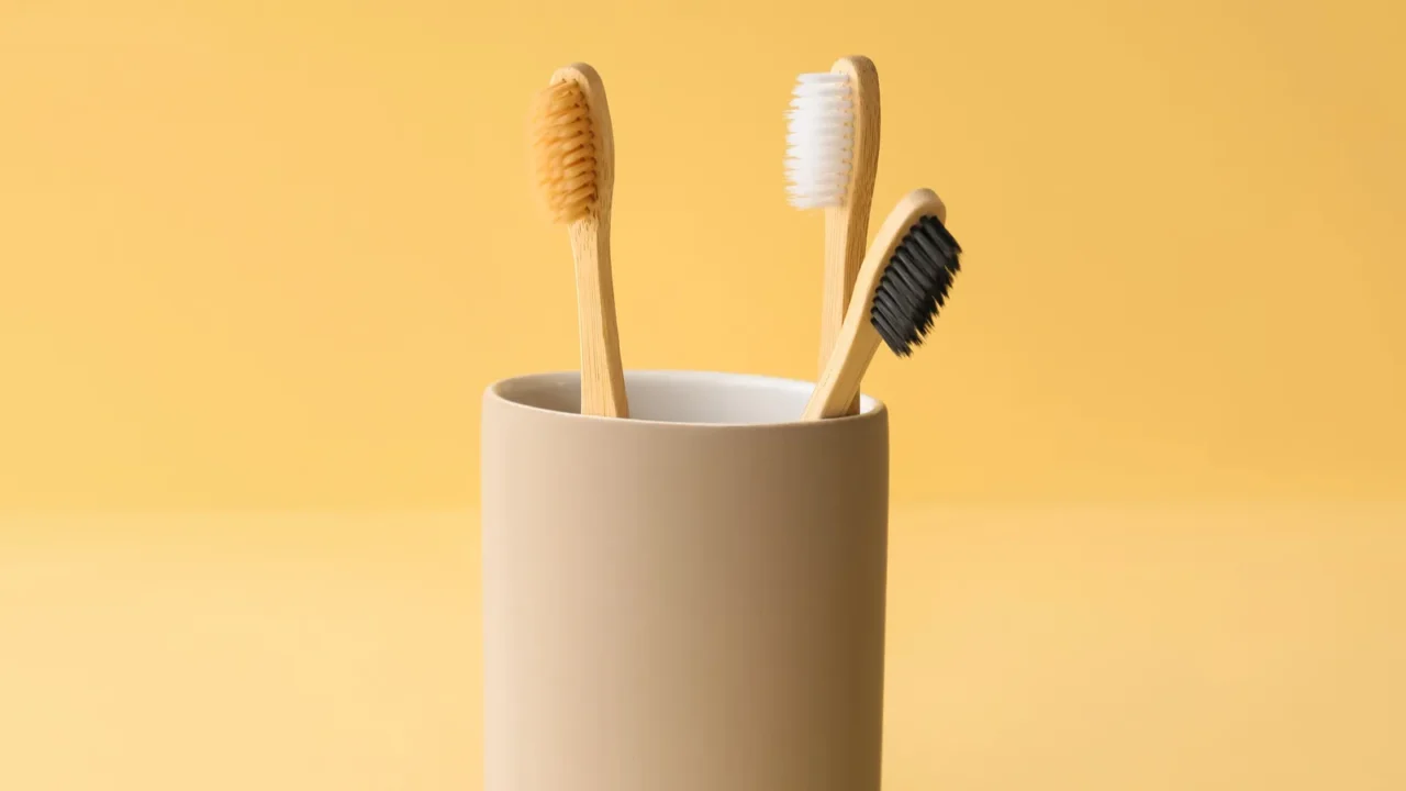 bamboo tooth brushes in holder on beige background