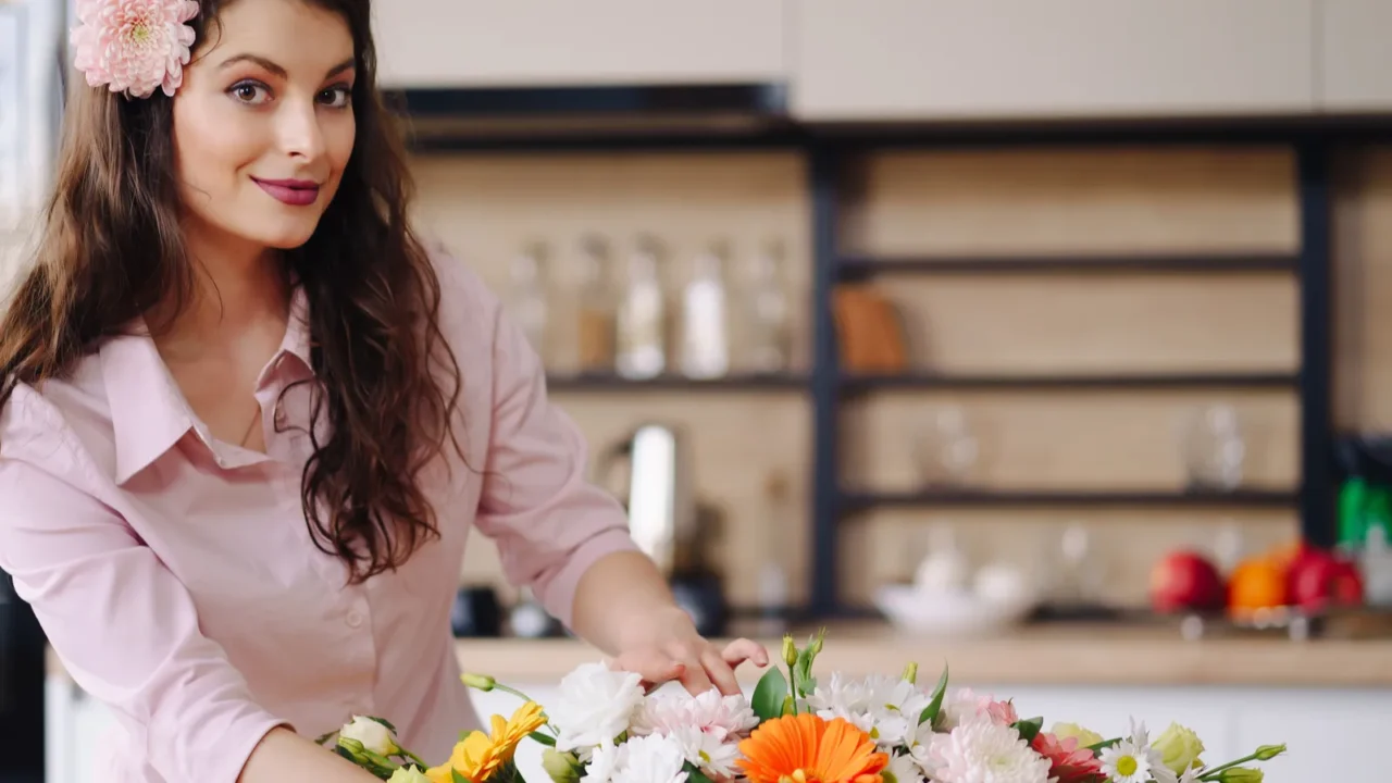 beautiful florist arranging a flower composition