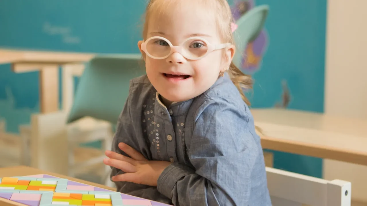 beautiful girl with down syndrome engaged in class