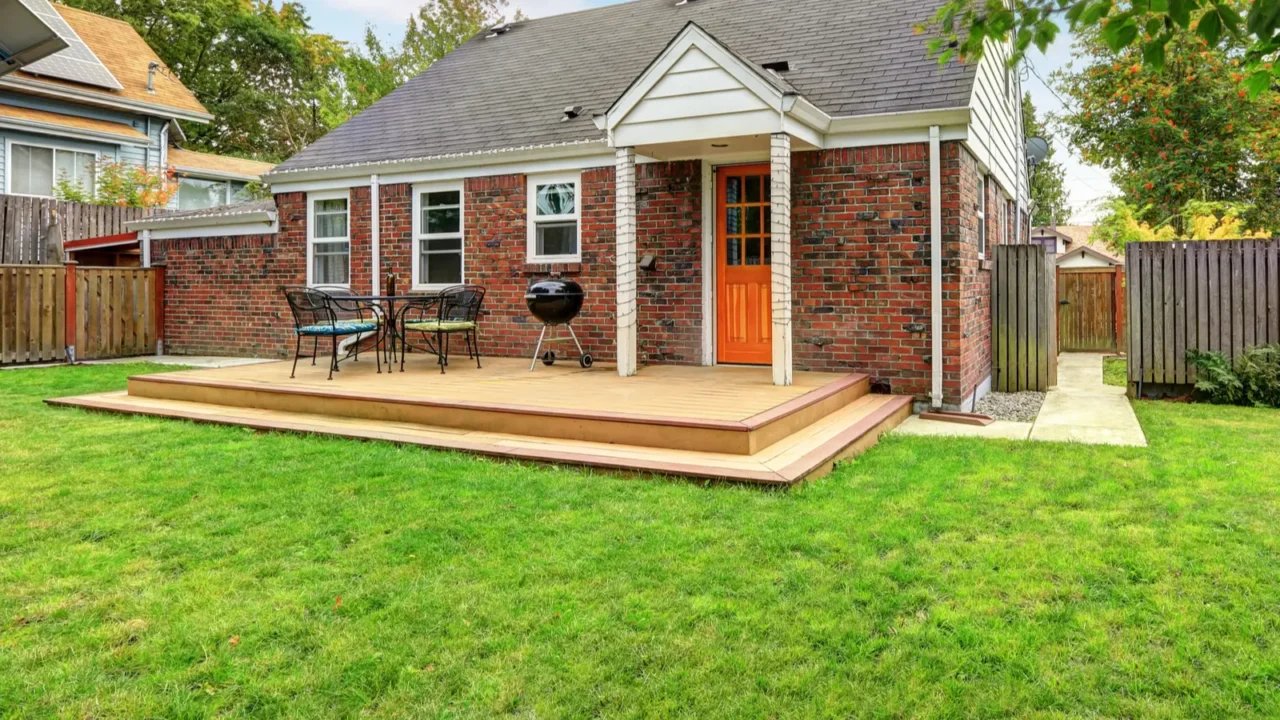 brick house exterior with walkout wooden deck