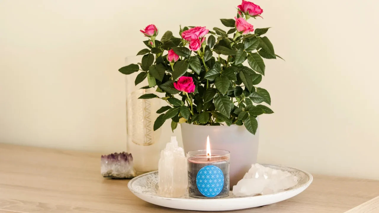 burning glass candle with homemade sign showing flower of life