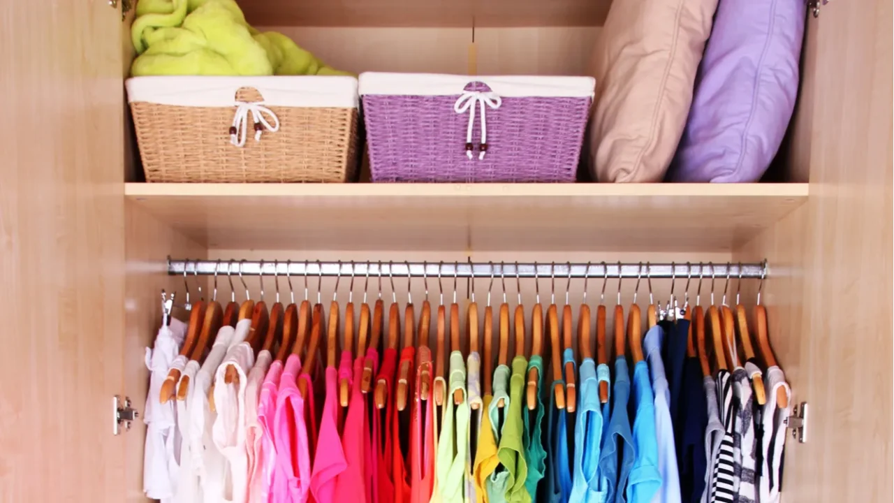 colorful clothes hanging in wardrobe