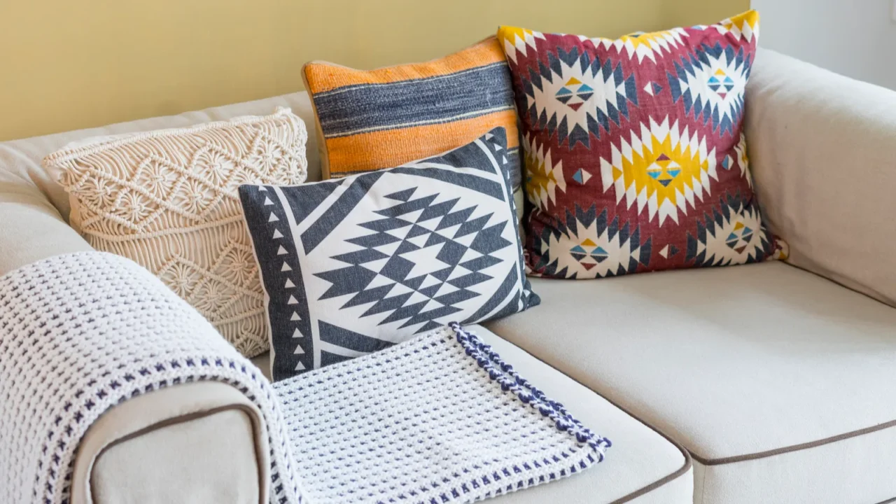 colorful pillow with native american pattern on biege sofa in