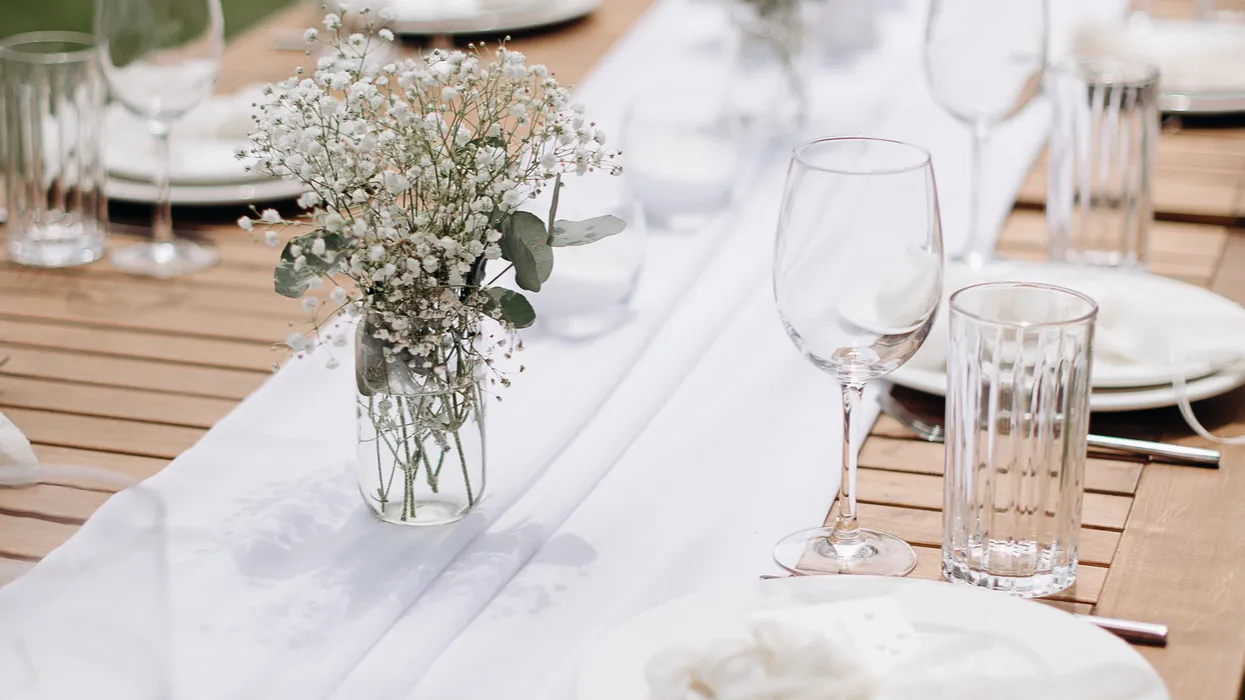 elegant outdoor wedding place setting with white ribbon