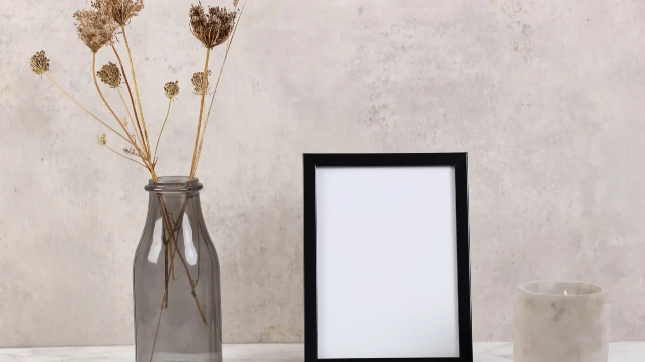 empty picture frame and vase with dry flowers minimalist