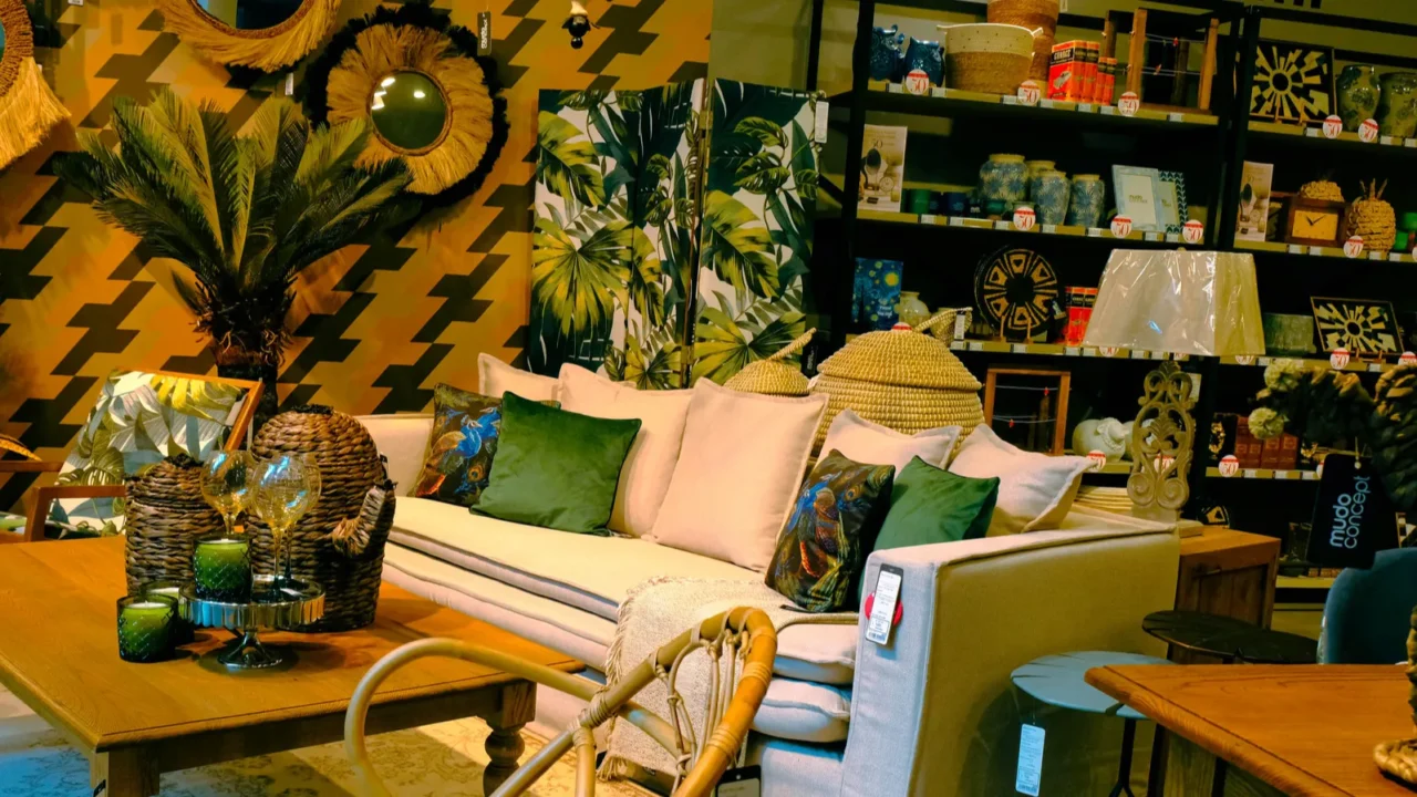 Elegant living room with a green and brown-themed decor, featuring a beige sofa and decorative pillows.