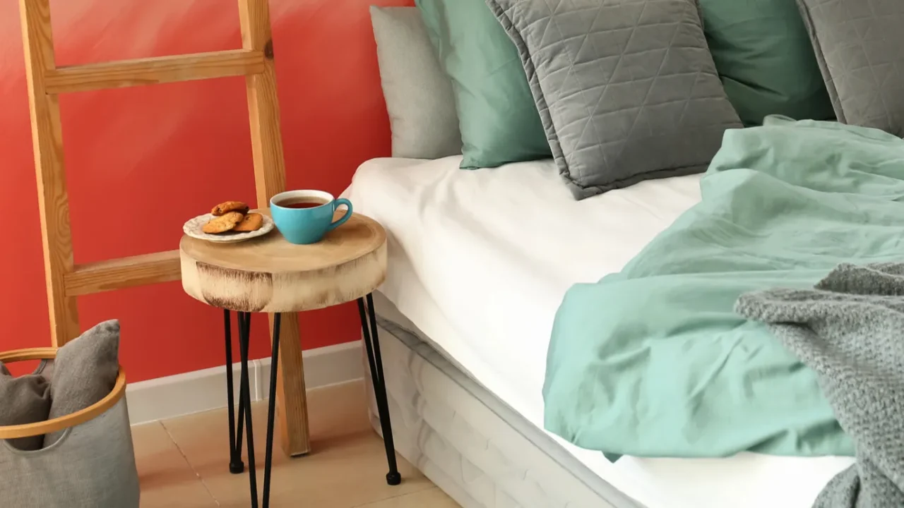 interior of room with comfortable bed near pink wall