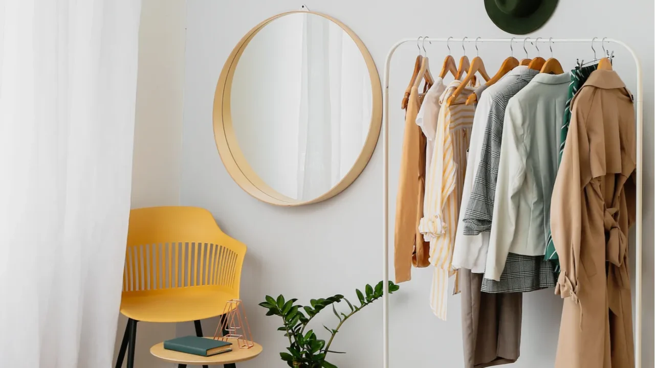 interior of stylish bedroom with clothes rack