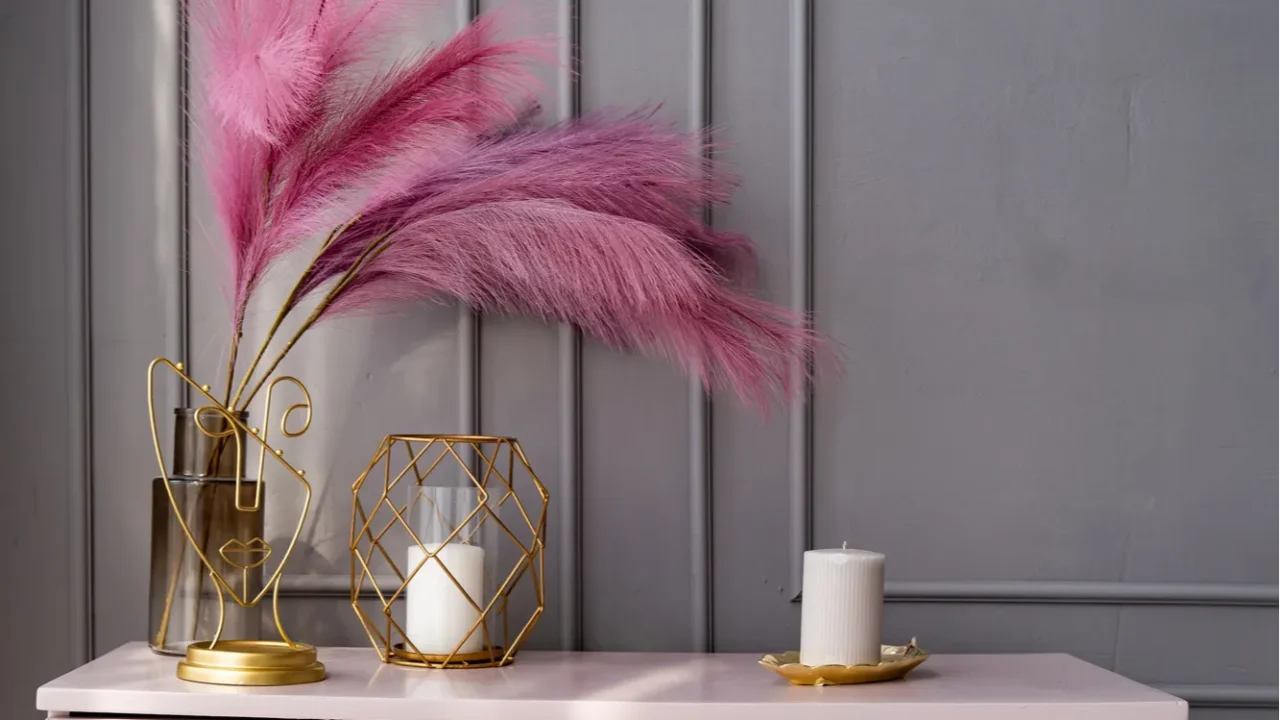 light pink dresser at the gray wall decorated with candles