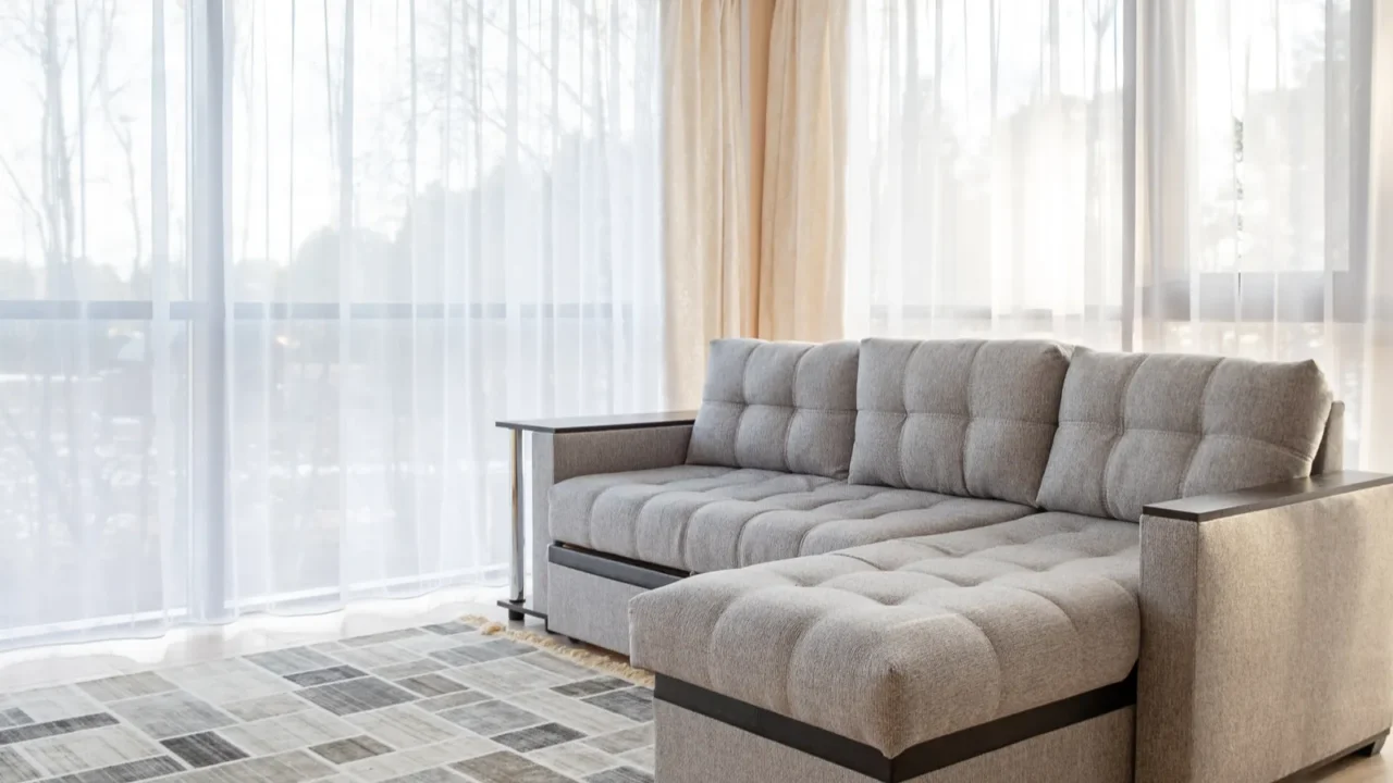 modern interior with big sofa and a large windows