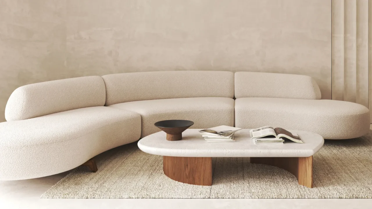 Modern, minimalist beige sofa with a wooden coffee table and neutral room decor.