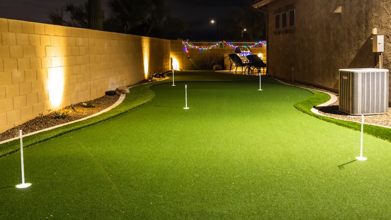 nighttime image of a personal home putting green with illuminated