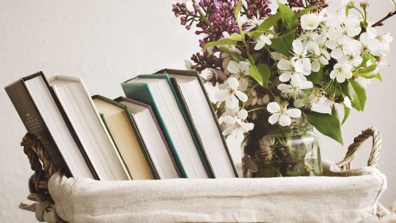 pile of books and spring flowers of a lilac and