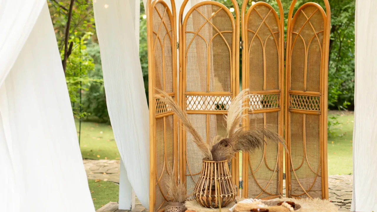 rattan vase with bouquet of dried floral spikelets ears and