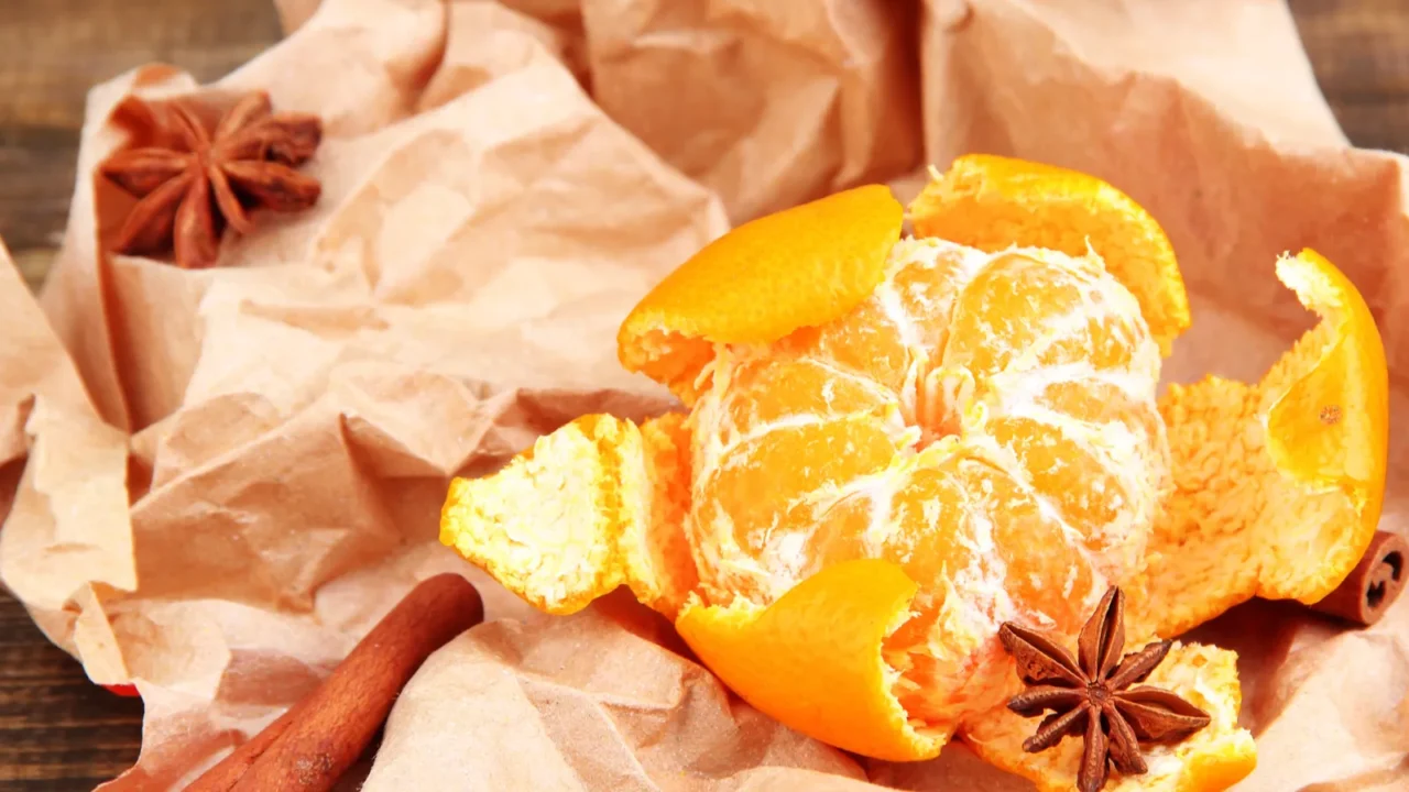 ripe sweet tangerine on wooden background closeup