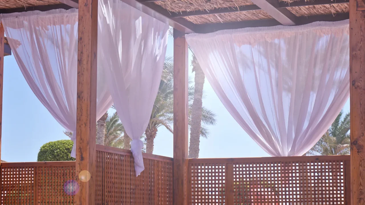 sheds awning with fabric white curtains on the seashore breeze