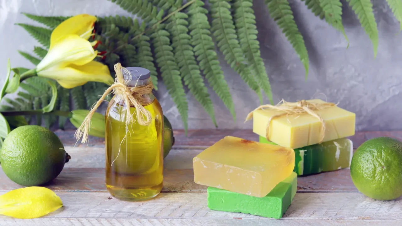 soap limes aromatic oil and fresh flowers on a wooden