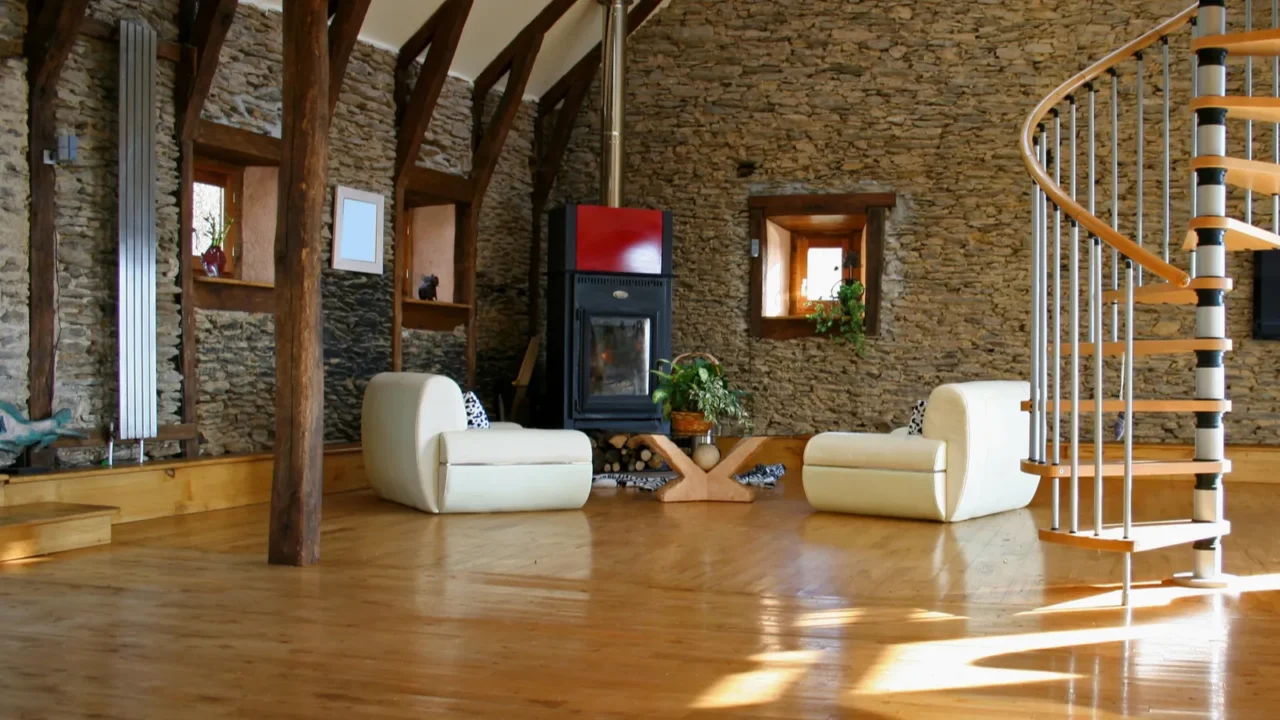 stair case coming down into the living room with fireplace