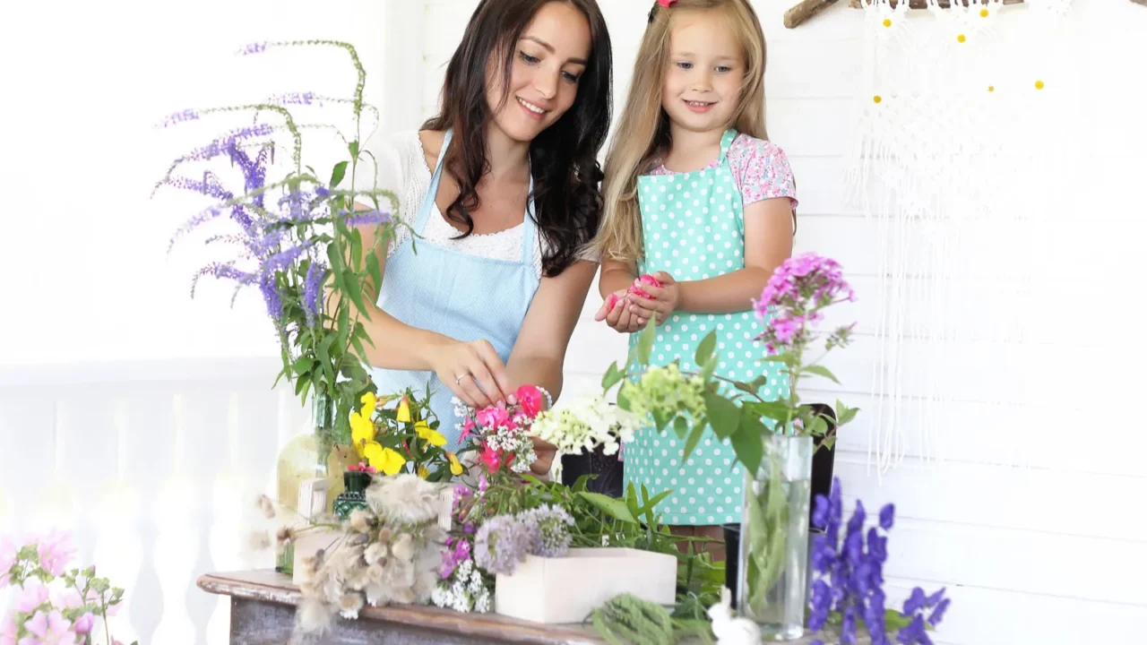 the mother and her little girl decorating a bouquet of