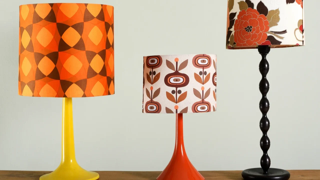 Vintage lamps with colorful patterned lampshades on a wooden table.