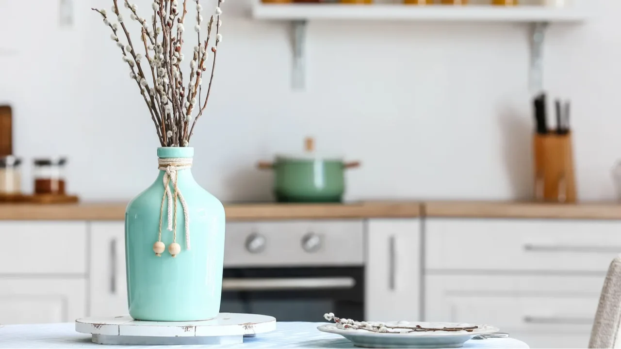 vase with willow branches on table in dining room