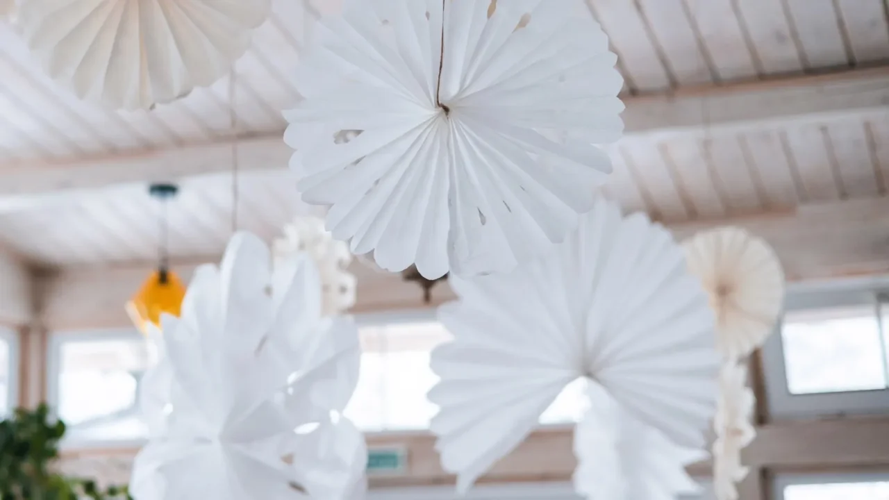 white and beige round paper handmade decorations on the ceiling