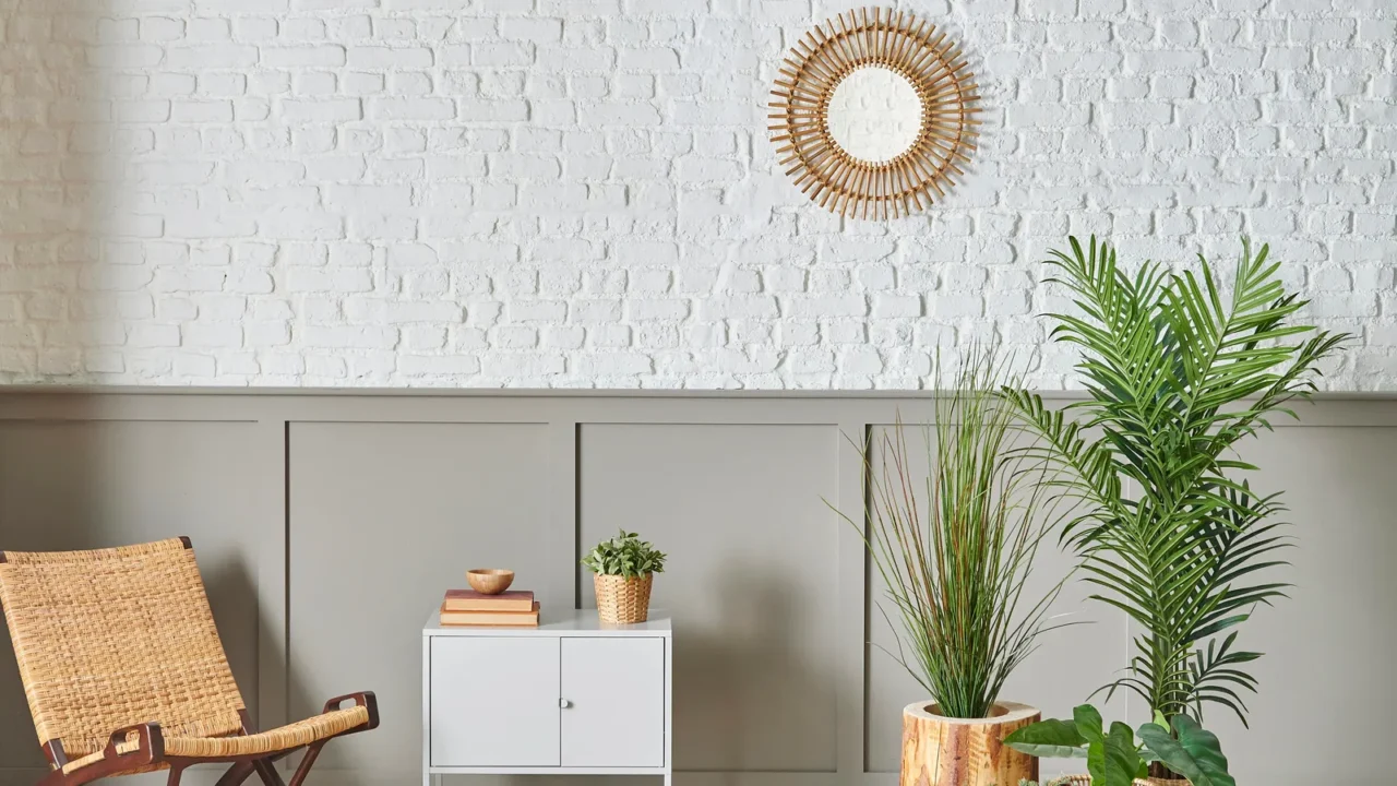wicker chair in front of the white brick and brown