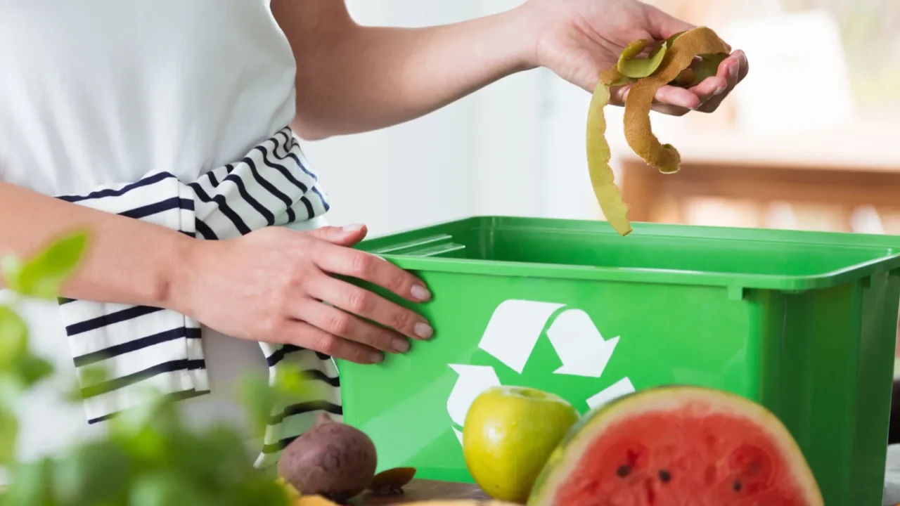 woman composting organic kitchen waste