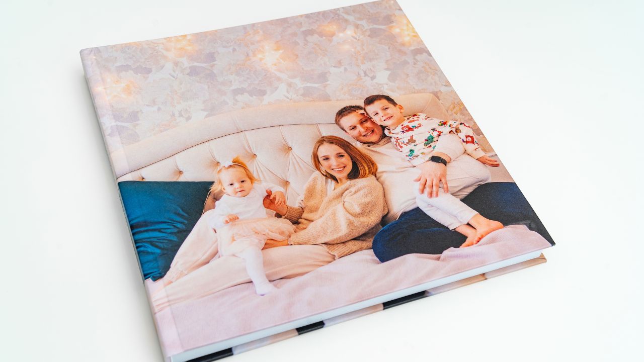 A personalized photo album of a family on a bed.