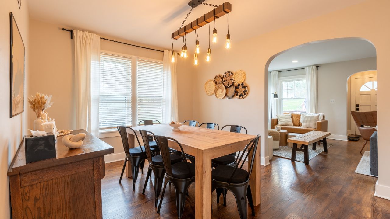 Elegant dining area with a wooden table, pendant lighting, and warm ambiance.